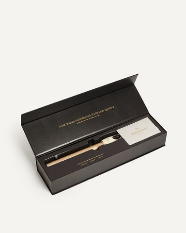 A black box containing a hair curling wand.
