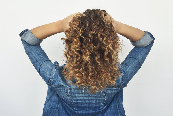Naturally curly hair using curl enhancing cream